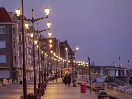 A promenade at dusk, illuminated by lanterns, people strolling along, quiet and peaceful