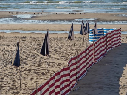 Striped windbreaks on the sandy beach with erected, closed parasols, de haan, Belgium, Europe
