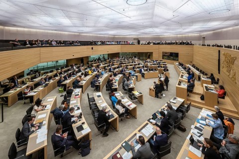 State parliament of Baden-Württemberg, plenum with state coat of arms and gallery with visitors.