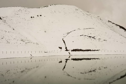 After snowfall in May: Riezler Alpsee, an artificial lake, snow pond, feeds the snow cannons that
