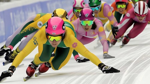Speed skaters in colorful uniforms race intensely on ice, demonstrating focus and competitive