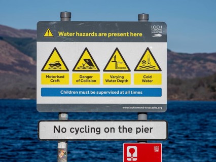 Warning sign at the beach, village Luss, Lake Lomond, potential water hazards, Scotland, UK