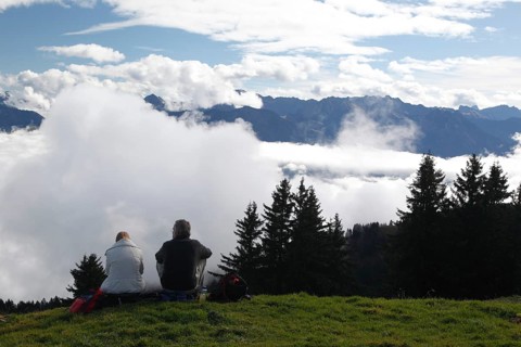 Hikers resting above the clouds on the Horner Group