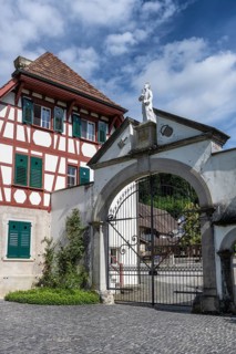 Lower entrance to Ittingen Charterhouse, a former Carthusian monastery with a statue of Bruno of