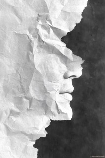 A textured paper piece creating an artistic face profile in black and white tones, AI generated