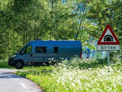 Camper van parked at the Sognefjord, road tunnel sign, Norway, Europe