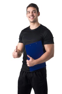 Personal trainer in a gym holding a notepad isolated in white
