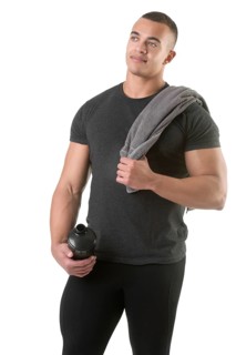 Man holding a protein shake after a workout in the gym, isolated in white