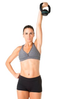 Fit woman working out with a kettlebell, isolated in white