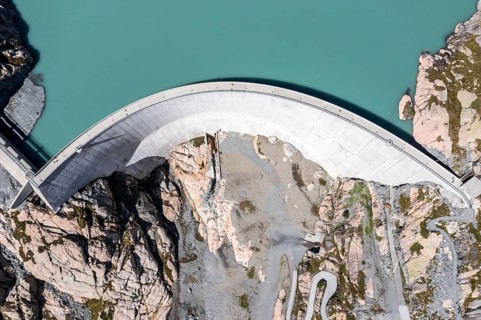 Aerial view of reservoir dam Barrage du Vieux Emosson and mountain hut Cabane Vieux Emosson,