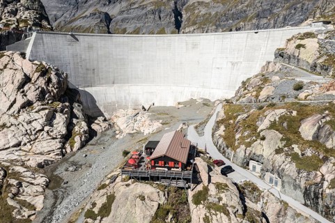 Aerial view of reservoir dam Barrage du Vieux Emosson and mountain hut Cabane Vieux Emosson,