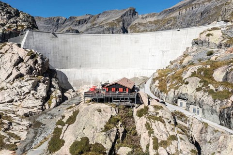 Aerial view of reservoir dam Barrage du Vieux Emosson and mountain hut Cabane Vieux Emosson,