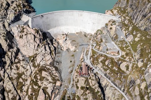 Aerial view of reservoir dam Barrage du Vieux Emosson and mountain hut Cabane Vieux Emosson,