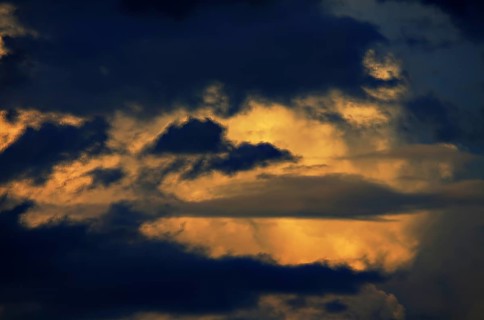 This cloud formation is a collection of cumulus clouds. The clouds in the picture are dark and