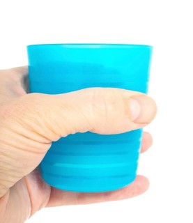 Empty blue plastic glass, held in a male persons hand