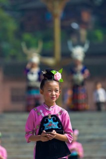 Xijiang, China, September 15, 2007: An Miao ethnic minority girl dressed in pink and black