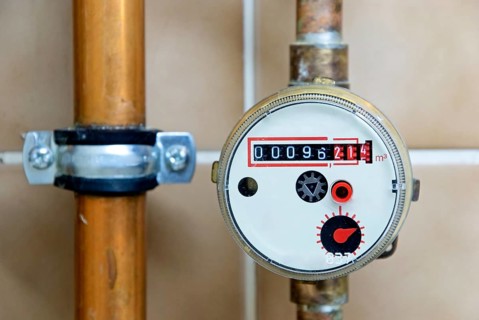 Water clock and copper pipes in a bathroom