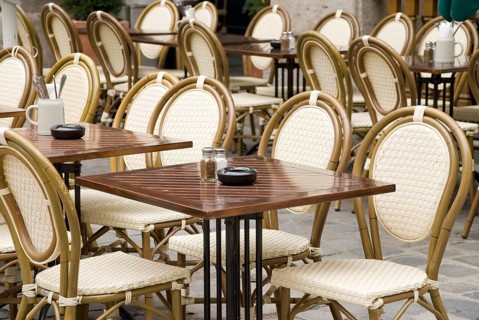 Typical munich stgreet cafe with wicker chairs