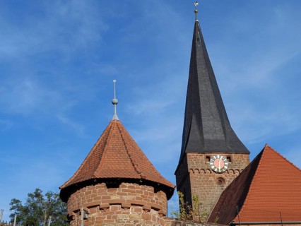 Gothic church with high tower and clock, red roof and blue sky, Kandel, Palatinate, Germany, Europe