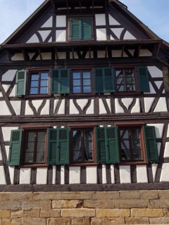 Traditional half-timbered house with green shutters and wooden structure, Kandel, Palatinate,