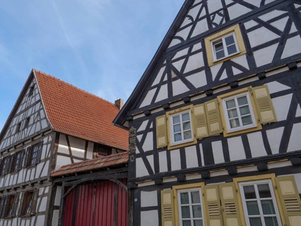 Traditional half-timbered houses with red roofs and shutters in a sunny daytime atmosphere, Kandel,