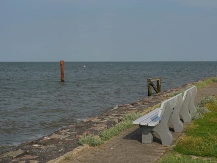 Benches along a stone path on the seashore, hallig hooge, schleswig-holstein, germany