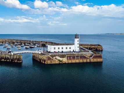 Scarborough Lighthouse and Harbour from a drone, Vincent Pier, Scarborough, North Yorkshire,