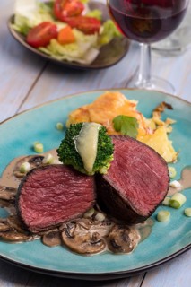 Sliced steak and potato gratin on a plate