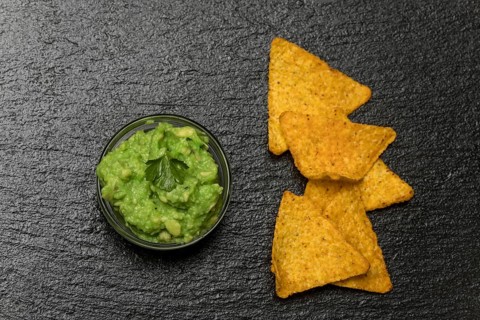 Small portion of guacamole on slate