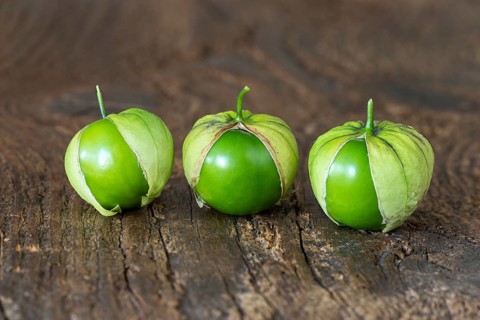 Closeup of tomatillos on a chopping board