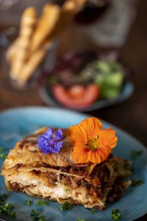 Fresh lasagne on a blue plate