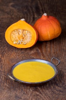 Close-up of pumpkin soup on wood