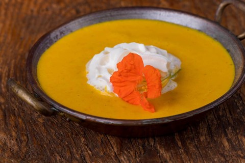 Close-up of pumpkin soup on wood