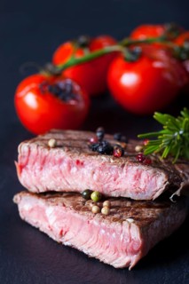 Juicy cut steak on a slate plate