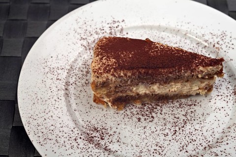 Tiramisu cake on a white plate