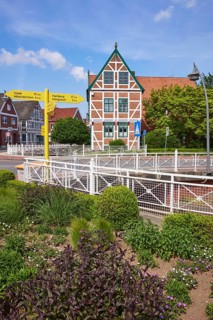 Town hall, signpost and flower bed in Jork, Altes Land, district of Stade, Lower Saxony, Germany,