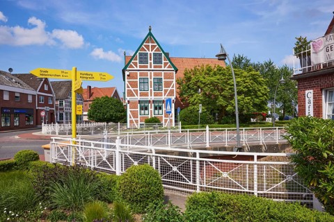 Town hall, signpost and flower bed in Jork, Altes Land, district of Stade, Lower Saxony, Germany,