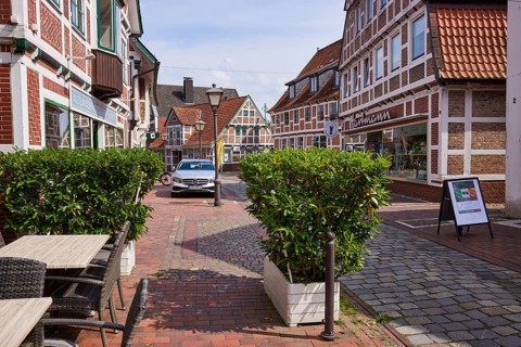 Outdoor area of a café and half-timbered houses in the centre of Jork, Altes Land, district of