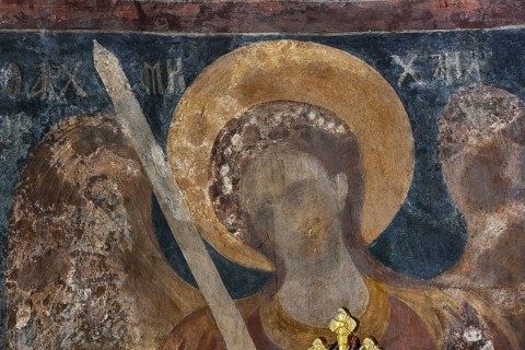 Wall painting of an angel with halo and sword in a church, weathered and damaged, Byzantine chapel