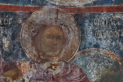 Close-up of a weathered mural in a church depicting a sacred figure, Byzantine Chapel of Agios