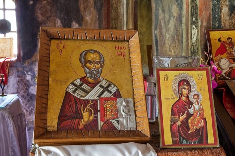 Two Christian icons in an old church setting. The pictures show saints in traditional orthodox