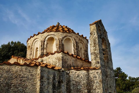 Close-up of an old church building with round windows and red bricks, Byzantine chapel Agios
