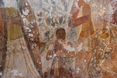 Close-up of old frescoes with religious figures and faded colours, child, Byzantine chapel Agios