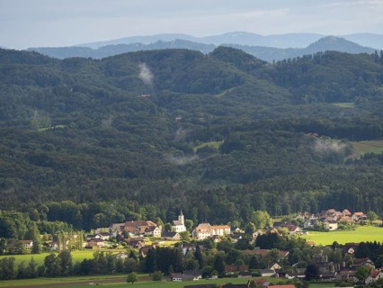 Evening light falls on the village of Heimschuh, hilly forest landscape, near Leibnitz, Styria,