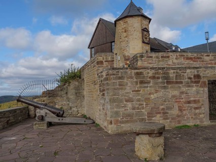 Historic castle with stone walls, a tower and a cannon under a partly cloudy sky, Waldeck, Hesse,