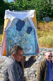 Man carrying a religious icon during a procession, Procession of the icon Panagia Skiadni from
