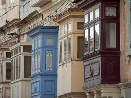 Colourful wooden balconies adorn historic buildings in an old town, valetta, mediterranean sea,