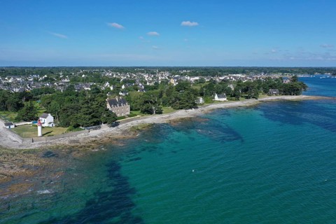 Aerial view coast of Loctudy with villas and lighthouse Phare de Langoz, department Finistere Penn