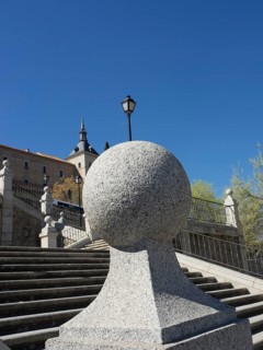 Stone steps leading up to a castle, flanked by lanterns and a stone sphere, Toledo, Spain, Europe