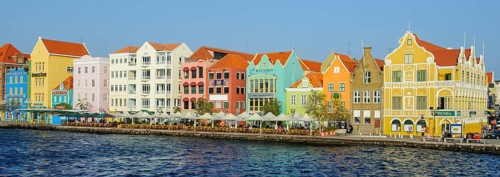 Panorama panoramic photo of landmark of Willemstad Curacao sunlit trading cade houses in colonial
